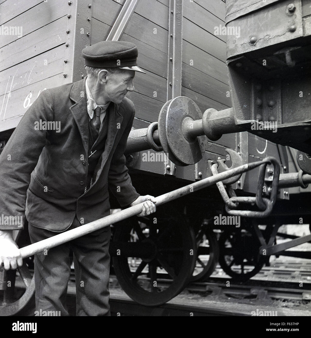 1950s-historical-picture-railway-guard-coupling-or-shunting-connecting-F637HP.jpeg