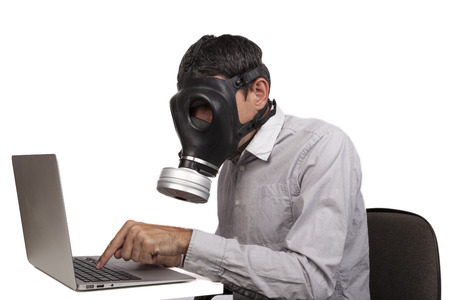28112552-man-with-gas-mask-working-with-silver-laptop-isolated-on-white-background.jpg
