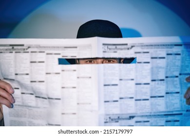 man-hiding-watches-through-newspaper-260nw-2157179797.jpeg