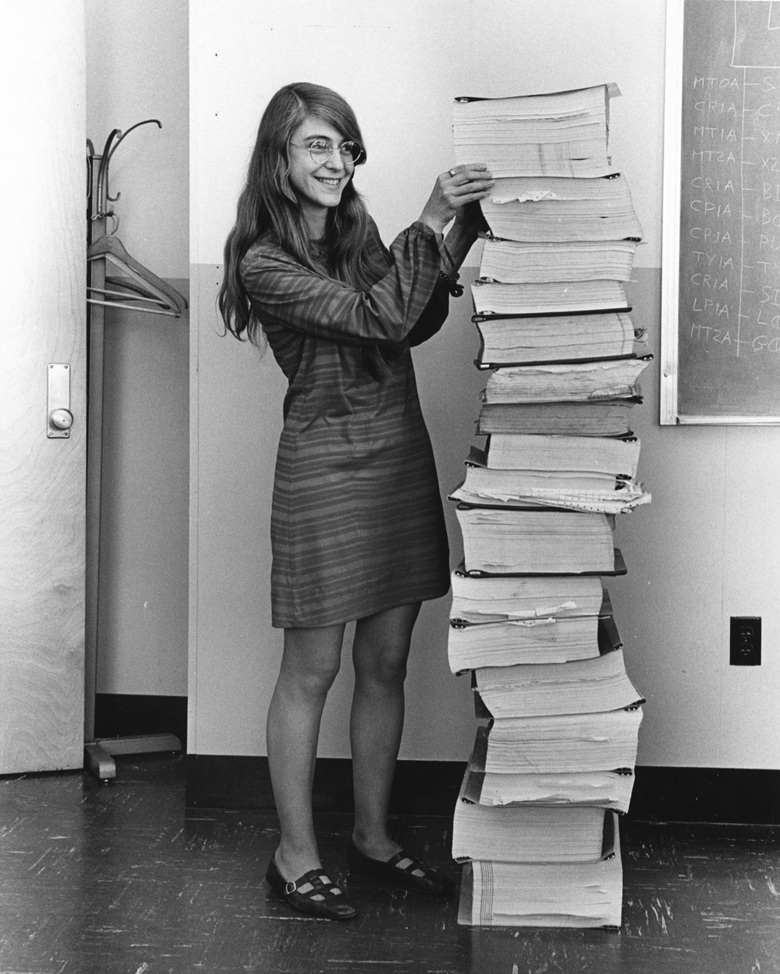 margaret-hamilton-standing-next-to-a-stack-of-punched-card-print-outs-of-the-in-flight-softwar...jpg